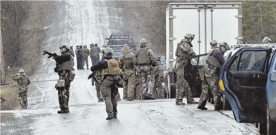  ?? AP PHOTO ?? ALL HANDS ON DECK: Numerous area law enforcemen­t officers converge on Bear Mountain Road to search for John Williams yesterday in Norridgewo­ck, Maine. Williams is a suspect in the fatal shooting of Somerset County Sheriff’s deputy Eugene Cole early...