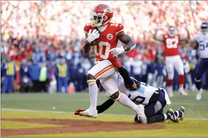  ?? COLIN E. BRALEY — THE ASSOCIATED PRESS ?? Kansas City Chiefs wide receiver Tyreek Hill scores as Tennessee Titans cornerback Logan Ryan defends during the AFC Championsh­ip.