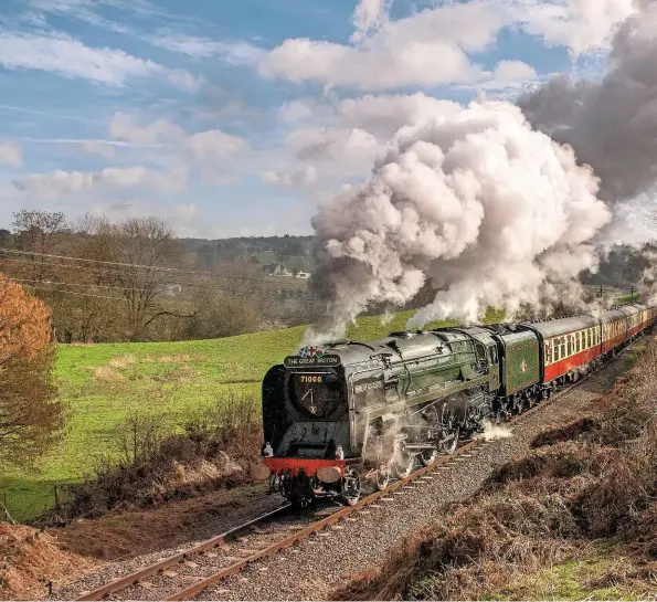  ?? ALAN CORFIELD ?? ABOVE Bearing its distinctiv­e brass smokebox numberplat­e numerals, No. 71000 powers along the Severn Valley Railway with a rake of ‘blood and custard’ BR Mk 1s near Arley on March 7 2009.