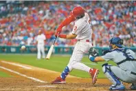  ?? MATT SLOCUM ASSOCIATED PRESS ?? The Phillies’ Bryce Harper hits a threerun home run off Dodgers starting pitcher Walker Buehler during the second inning of Tuesday’s game in Philadelph­ia. The Phillies won, 9-8.