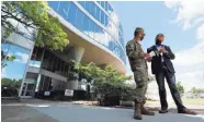  ??  ?? Gov. Bill Lee talks with Maj. Gen. Bob Whittle of the Army Corps of Engineers outside the former Commercial Appeal building.