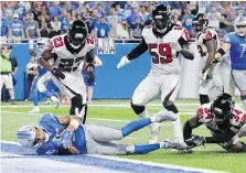  ?? THE ASSOCIATED PRESS ?? Lions receiver Golden Tate falls into the end zone after making what appeared to be the game-winning catch.