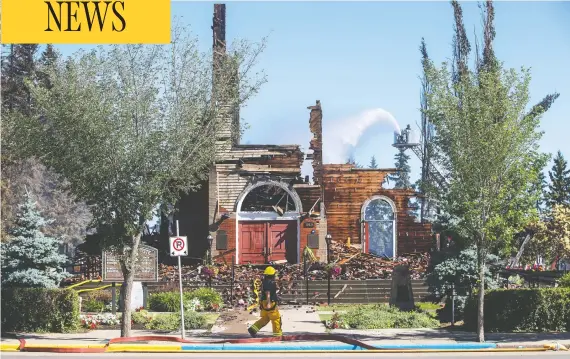  ?? JASON FRANSON / THE CANADIAN PRESS ?? Firefighte­rs put out hot spots on Wednesday after a suspicious fire burned down St. Jean Baptiste Parish Church in Morinville, northern Alberta.