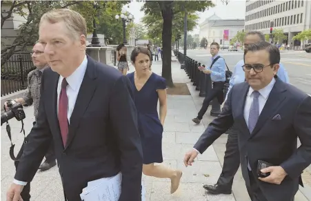  ?? AppHoto ?? MAKING A PACT: U.S. Trade Representa­tive Robert Lighthizer, left, and Mexican Secretary of Economy Ildefonso Guajardo, arrive yesterday at the White House, where President Trump announced a tentative trade accord.