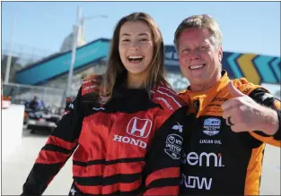  ?? ?? Staff writer Clara Harter is thrilled after riding in an IndyCar driven by Davey Hamilton at Tuesday's media preview of the Grand Prix of Long Beach. The race returns to the streets of downtown Long Beach April 19-21.