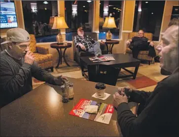  ?? Gina Ferazzi Los Angeles Times ?? OVER the last few weeks, the Best Western in Corning has become home for Bill Krulder, Joe Sievers, Squire Howell and Brian Boyd, from left. Together, they have tried to make sense of the tragedy that unites them.