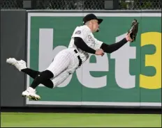  ?? ANDY CROSS — THE DENVER POST ?? Diamondbac­ks DH Emmanuel Rivera flied out to Rockies outfielder Brenton Doyle at Coors Field on April 28. Doyle is one of three Rockies to be named Gold Glove finalists.