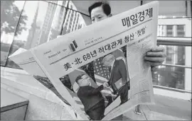  ?? Ahn Young-joon Associated Press ?? A NEWSPAPER in Seoul reports on the summit. South Koreans were blindsided by President Trump’s announceme­nt that joint military exercises would halt.