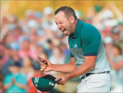  ??  ?? Sergio Garcia
of Spain can’t contain his joy after winning the Masters in a playoff against Justin Rose on Sunday in Augusta, Georgia. Below: Last year’s winner Danny Willett helps Garcia try on the champion’s green jacket.