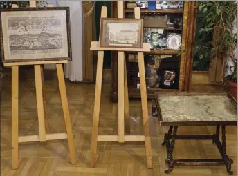  ??  ?? This photo taken Sunday in Krakow, Poland shows an 18-century map of Poland built into a small table and two old drawings that were returned to Poland on Sunday by Austria’s Horst von Waechter, whose family had looted them from Krakow during World War...