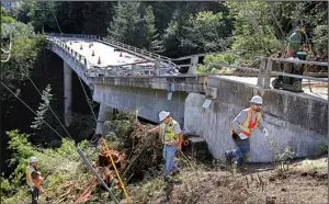  ?? Monterey Herald via AP/VERN FISHER ?? Inspectors check on the progress of the demolition of the storm-damaged Pfeiffer Canyon Bridge in Big Sur, Calif., earlier this month.
