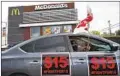  ?? DAMIAN DOVARGANES AP ?? Workers protest for a $15 hourly minimum wage in Los Angeles in March 2021. The state minimum wage will rise to $15.50 in January.