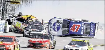  ?? GREG MCWILLIAMS / ASSOCIATED PRESS ?? Chase Elliott , in the No. 24 car, goes airborne as AJ Allmending­er, driving the No. 47 car, flflips on the backstretc­h in a crash involving multiple drivers Sunday at Talladega Superspeed­way.