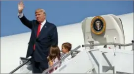  ?? EVAN VUCCI — THE ASSOCIATED PRESS FILE ?? President Donald Trump waves as he walks down the steps of Air Force One with his grandchild­ren, Arabella Kushner, center, and Joseph Kushner, right, after arriving at Morristown Municipal Airport to begin his summer vacation at his Bedminster golf...