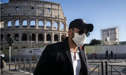  ?? Photograph: Antonio Masiello/Getty Images ?? A tourist wearing a face mask visits the Colosseum in Rome, Italy, on 24 February.