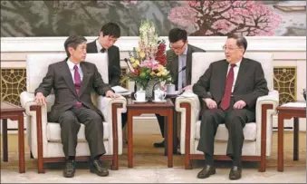  ?? LIU ZHEN / CHINA NEWS SERVICE ?? Yu Zhengsheng, (right) chairman of the Chinese People’s Political Consultati­ve Conference National Committee, meets Masahiko Komura, who led the visiting delegation of the Japan-China Friendship Parliament­arians’ Union and is vice-president of Japan’s...