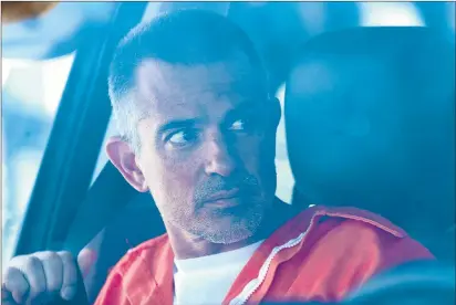  ?? PATRICK RAYCRAFT/HARTFORD COURANT PHOTOS ?? Fotis Dulos, still clad in a orange prison jumpsuit, sits in the passenger seat of his attorney’s vehicle after he was escorted from the Stamford courthouse by state police and judicial marshals.