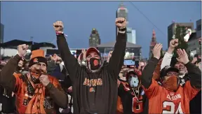  ?? DAVID DERMER — THE ASSOCIATED PRESS ?? Fans celebrate the Browns’ second-round pick, Jeremiah Owusu-Koramoah on April 30 in Cleveland.