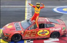  ?? Emilee Chinn / Getty Images ?? Joey Logano celebrates after winning at Darlington on Sunday.