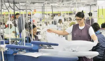  ?? PHOTO: ARMAND HOUGH ?? Workers busy on the production line of Cape Town Prestige Clothing factory. Disappoint­ing mining and manufactur­ing data have raised fears again of a looming recession.