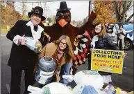  ?? Ned Gerard / Hearst Connecticu­t Media ?? Dr. Bruce Sofferman, his daughter Sophia, wife Deborah and Brendan Carey dressed as a turkey, pose during the annual Thanksgivi­ng food collection in front of Smile Dental Center in Shelton on Nov. 17, 2021.