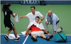  ?? AL BELLO/GETTY IMAGES ?? Jack Sock of the U.S., centre, is one of a Grand Slam record 14 players who have had to retire during a match so far at the U.S. Open.