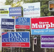  ?? STAFF PHOTO BY ANGELA ROWLINGS ?? PRIMARY MATTERS: Campaign signs adorn a fence yesterday near the Boston Public Library’s Adams Street Branch in Dorchester.