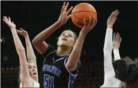  ?? REBECCA SLEZAK — SPECIAL TO THE DENVER POST ?? Grandview’s Sienna Betts splits Monarch’s Caroline Walley, left, and Arezo Safi to shoot the ball during the Class 6A championsh­ip game Saturday at Denver Coliseum.