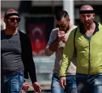  ?? AFP ?? Patients walk on Taksim Square after a hair transplant surgery. —