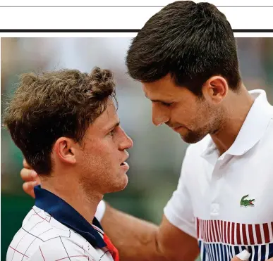  ?? AP ?? Heated: Djokovic embraces Schwartzma­n after his fiercely-contested victory in Paris