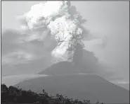  ?? AP/FIRDIA LISNAWATI ?? Mount Agung spews smoke and ash Tuesday in Karangasem on the Indonesian island of Bali.