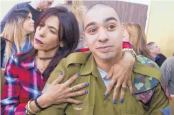  ?? JIM HOLLANDER ?? Israeli soldier Elor Azaria is embraced by his mother at the start of his sentencing hearing Tuesday in Tel Aviv, Israel. Azaria was sentenced to 18 months.