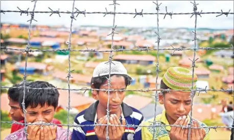  ?? AFP ?? Rohingya refugees pray at the Kutupalong refugee camp in Ukhia, Bangladesh, on August 25.