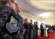  ?? PETE BANNAN — DIGITAL FIRST MEDIA ?? Downingtow­n paramedic Shiloh Kramer, a member of the Chester County Regional Emergency Response Team, listens as Chester County District Attorney Thomas Hogan awards the County SWAT teams with the Officer of the Year Award Friday at the Historic...