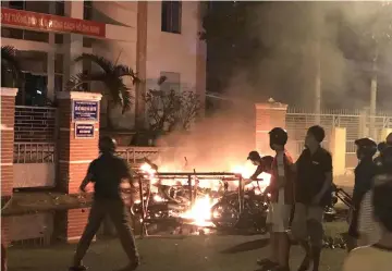  ??  ?? Protesters burn motorcycle­s in front of a provincial office in Vietnam’s south central coast Binh Thuan province in response to legislatio­n on three special economic zones that would grant 99-year leases to companies. — AFP photo