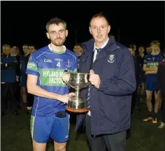  ??  ?? Wicklow GAA Chairman Martin Fitzgerald presents AGB captain Karl Kirwan with the Corn an Sagart after the Division 1A final replay.