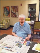  ??  ?? STEVE SINOVIC/JOURNAL Roger Proctor enjoys a leisurely read at Elan Santa Monica. He moved into his “studio plus” apartment in April.