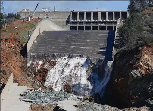  ?? (File Photo/AP/Rich Pedroncell­i) ?? Water flows down the Oroville Dam’s crippled spillway Feb. 28, 2017, in Oroville, Calif.