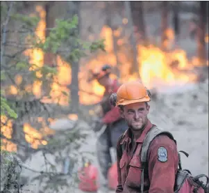  ?? CP PHOTO ?? A B.C. Wildfire Service firefighte­r looks on while conducting a controlled burn to help prevent the Finlay Creek wildfire from spreading near Peachland, B.C., on Thursday, Sept. 7.