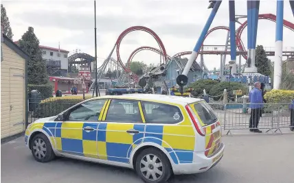  ??  ?? > Police at Drayton Manor Theme Park in Tamworth after yesterday’s tragedy