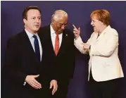  ?? John Thys / AFP / Getty Images ?? Britain Prime Minister David Cameron, left, gestures as Portuguese Prime Minister Antonio Costa talks with German Chancellor Angela Merkel in Brussels.