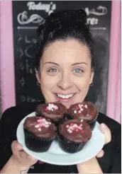  ?? DAVID BEBEE WATERLOO REGION RECORD ?? Priscilla Inacio holds Cambridge bakery Tiny Cakes' Love Potion 99. The cupcake is a top seller on Valentine’s Day.
