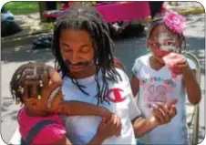  ??  ?? John Tucker of Trenton enjoys the day out with his cousins, Alexis and Jayla Hill of Willingbor­o, N.J.