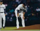  ?? TED S. WARREN — THE ASSOCIATED PRESS ?? Mariners starter James Paxton stands to the side of the mound after suffering a forearm injury during the second inning Tuesday night.