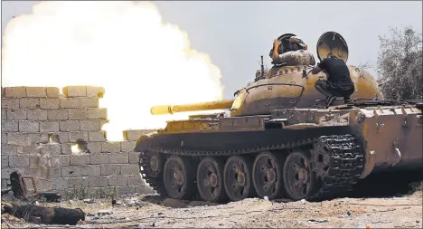  ?? MAHMUD TURKIA/AFP ?? A tank opens fire June 13 south of Tripoli, Libya, in clashes with forces loyal to strongman Khalifa Haftar.