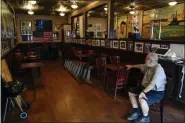  ?? THE ASSOCIATED PRESS ?? Joe Bastone, owner of Yankee Tavern, sits in an empty dining room before the Boston Red Sox played the New York Yankees on Friday, Aug. 14, 2020, in New York. The coronaviru­s pandemic has been especially hard on businesses that rely on ballpark traffic, eliminatin­g crowds at major league games, and leading to rules that limit the amount of people they can have inside their doors at the same time.