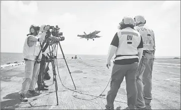  ??  ?? Hosts Beth Wilson and Marty Kelsey, right, film an episode of “STEM in 30” aboard the aircraft carrier Dwight D. Eisenhower. The webcast will air on Oct 18. — National Air and Space Museum photo