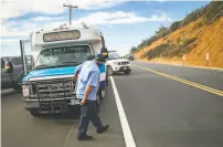  ??  ?? A Monterey Salinas Transit bus driver checks for traffic pulling out of the parking area at Bixby Creek Bridge.