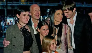  ??  ?? BELOW RIGHT: Demi with her three daughters, including middle child Scout (centre), their father, actor Bruce Willis (back left) and actor Ashton Kutcher (back right), whom Demi later married.