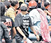  ??  ?? Deng Jia Xi, above, photograph­ed minutes before she was shot dead at a rally in Mandalay, and, right, in a Facebook post